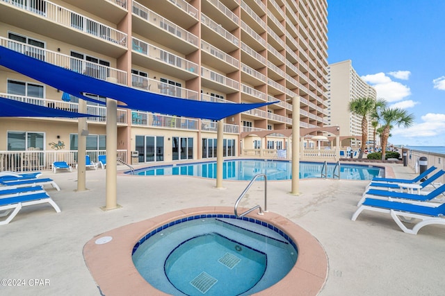 view of pool with a community hot tub