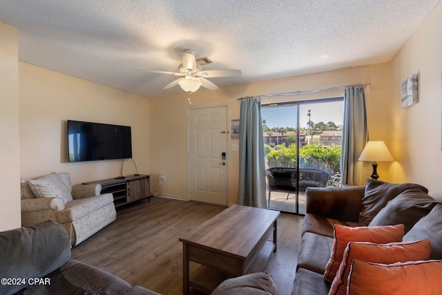 living room featuring a textured ceiling, hardwood / wood-style floors, and ceiling fan