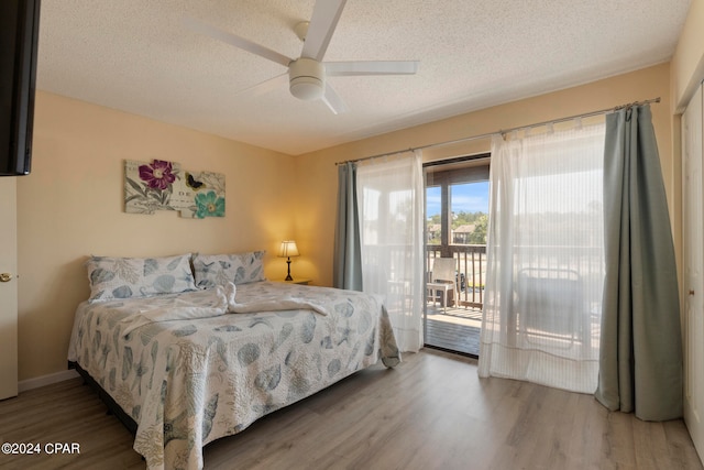 bedroom with a textured ceiling, ceiling fan, hardwood / wood-style floors, and access to exterior