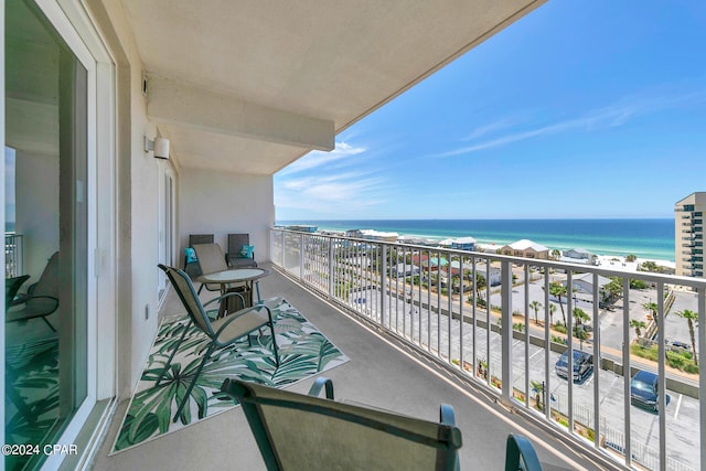 balcony with a water view and a beach view