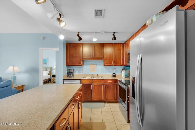 kitchen with light tile patterned floors, visible vents, appliances with stainless steel finishes, light countertops, and a sink