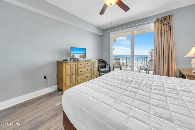 bedroom featuring access to exterior, ceiling fan, baseboards, and wood finished floors