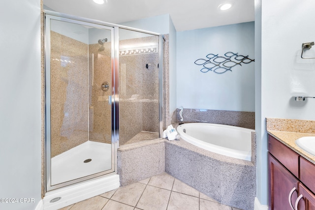 bathroom featuring vanity, a shower stall, a bath, and tile patterned floors