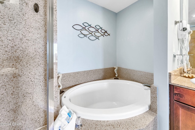 bathroom featuring a bath and vanity