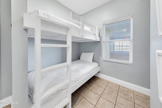 bedroom with tile patterned floors and baseboards