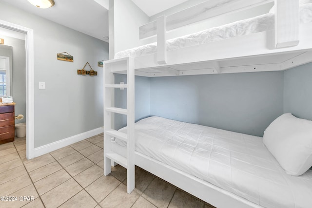 bedroom featuring baseboards and light tile patterned floors