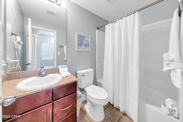 full bathroom featuring visible vents, toilet, shower / bath combo, vanity, and tile patterned floors