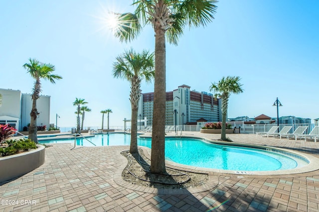 pool featuring a patio area and fence