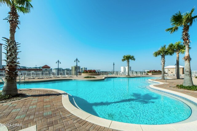 view of swimming pool with pool water feature