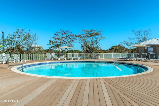 view of swimming pool with a wooden deck