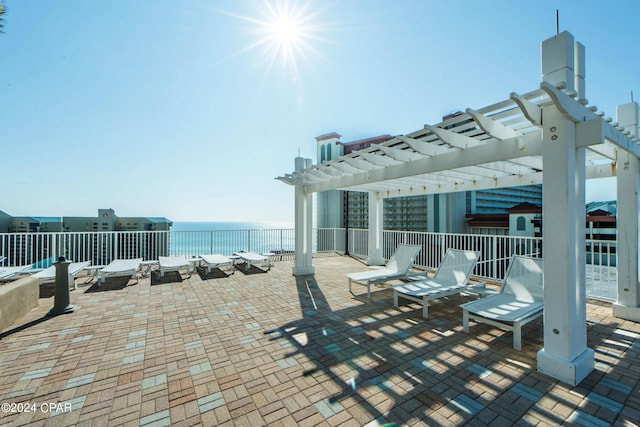 view of patio featuring a water view and a pergola