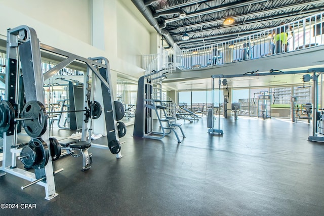 exercise room with a high ceiling