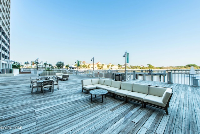 wooden terrace with an outdoor living space