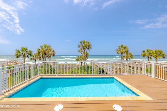 view of swimming pool with a water view