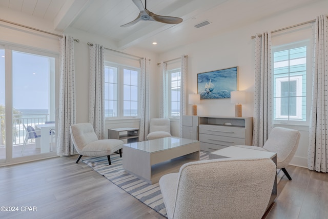 living room with beam ceiling, ceiling fan, and light hardwood / wood-style floors