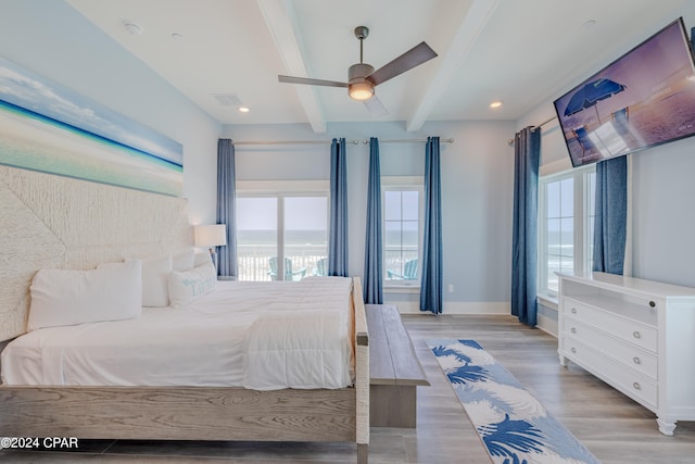 bedroom with beam ceiling, ceiling fan, and light hardwood / wood-style floors