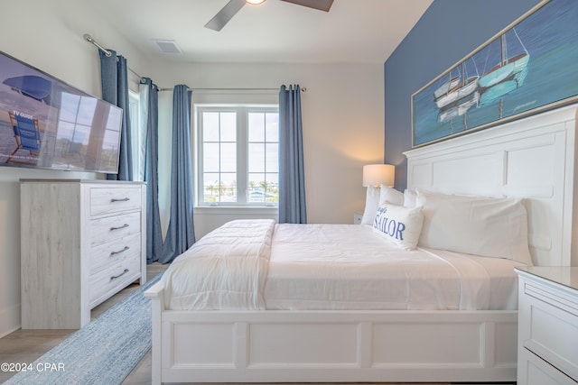 bedroom featuring light hardwood / wood-style floors and ceiling fan