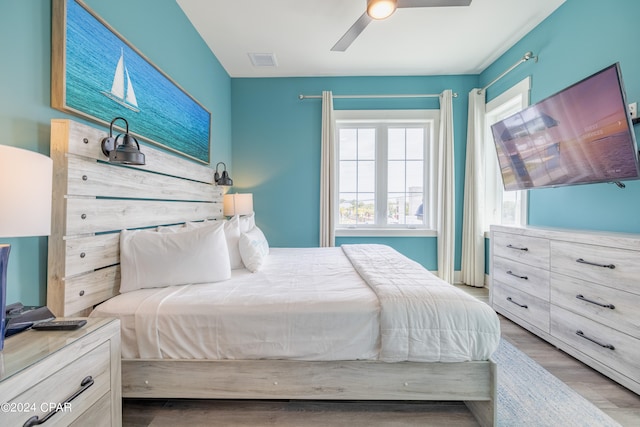 bedroom with light hardwood / wood-style flooring and ceiling fan