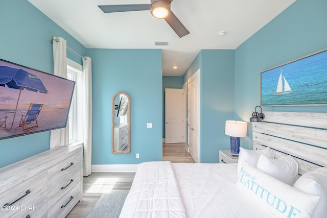 bedroom featuring light hardwood / wood-style floors and ceiling fan