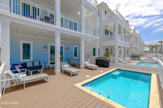 view of swimming pool with an outdoor living space and grilling area