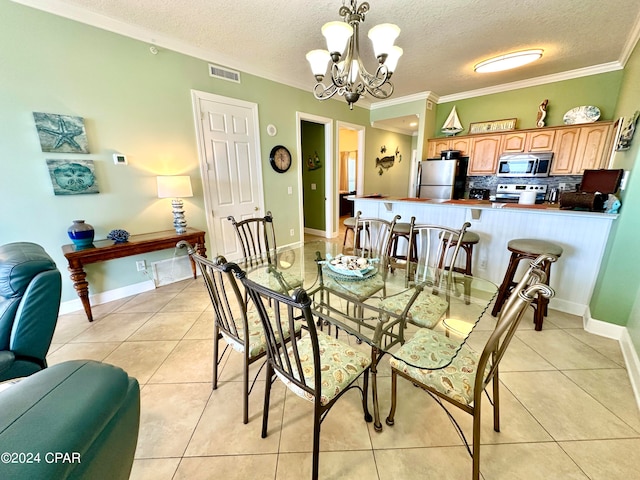 dining area with an inviting chandelier, light tile flooring, crown molding, and a textured ceiling