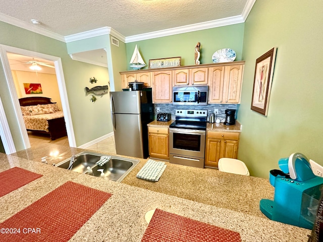 kitchen with ornamental molding, backsplash, stainless steel appliances, and a textured ceiling