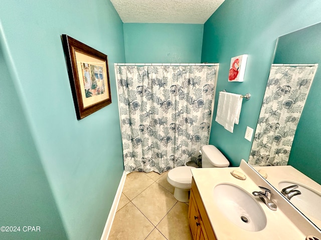 bathroom with a textured ceiling, oversized vanity, toilet, and tile flooring