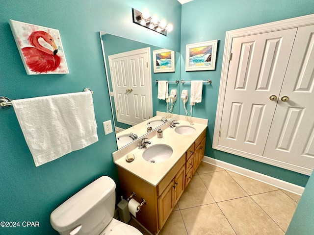 bathroom featuring tile flooring, double sink vanity, and toilet