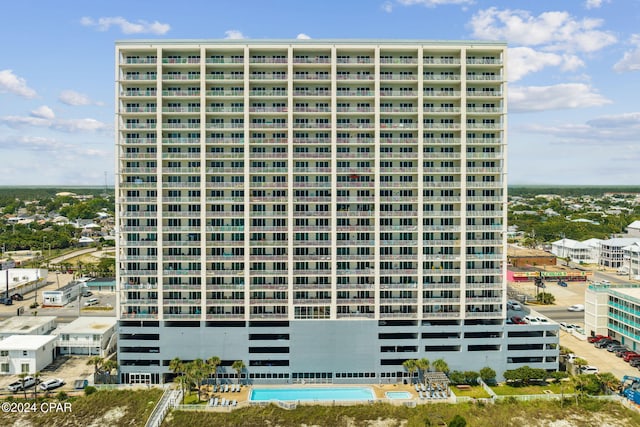 view of building exterior featuring a community pool