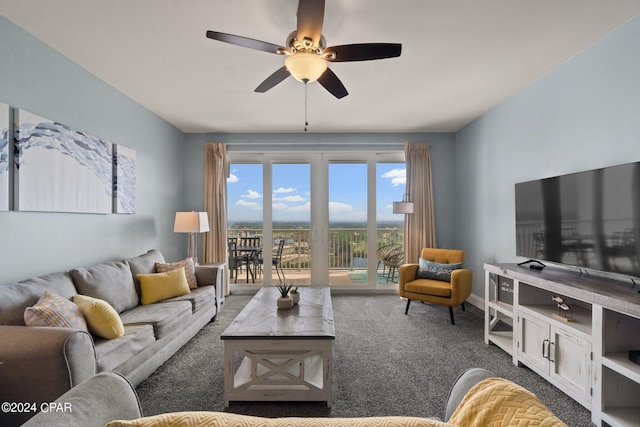 living room featuring ceiling fan and dark carpet