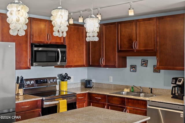 kitchen featuring stainless steel appliances, light countertops, and a sink