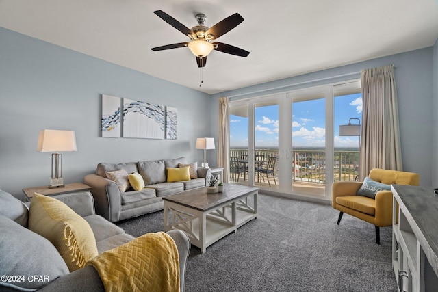 living area featuring ceiling fan and carpet