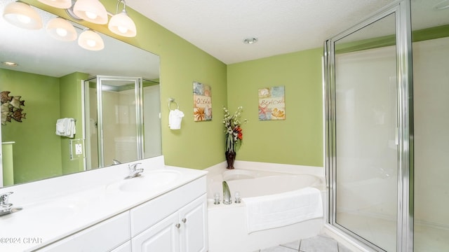 bathroom featuring independent shower and bath, tile floors, vanity, and a textured ceiling