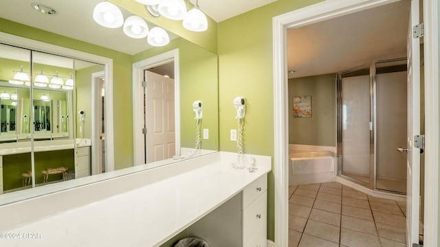 bathroom with tile flooring, vanity, and separate shower and tub