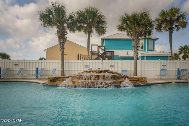 view of swimming pool featuring pool water feature