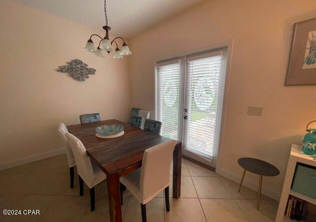 tiled dining area with an inviting chandelier