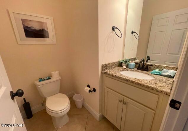 bathroom featuring vanity, tile patterned floors, and toilet