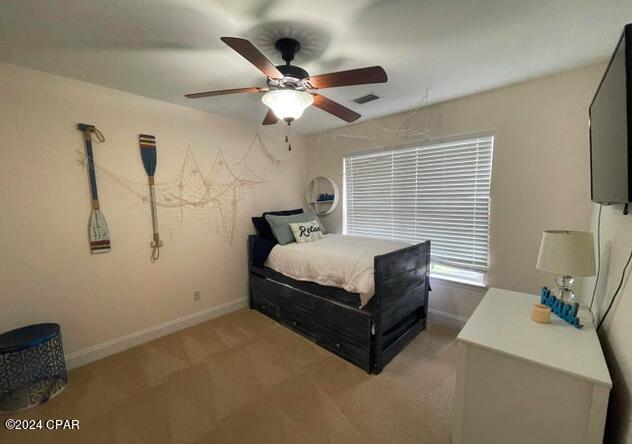 bedroom with light colored carpet and ceiling fan