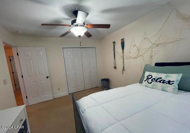 bedroom featuring ceiling fan and a closet