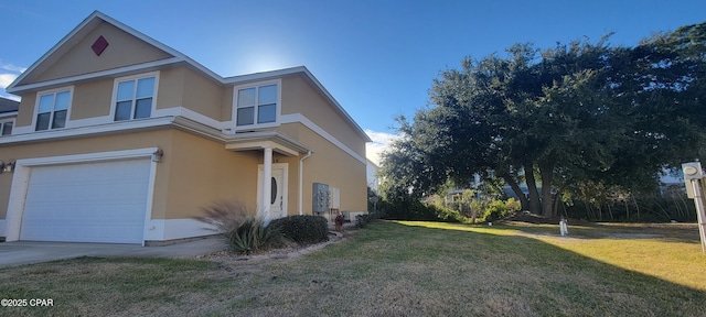 view of side of property with a garage and a lawn