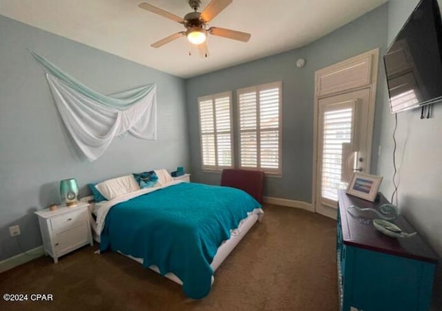 bedroom with ceiling fan and dark colored carpet