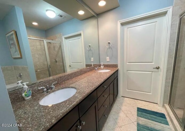 bathroom with an enclosed shower, tile patterned floors, and vanity