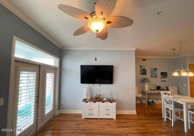 living room featuring ceiling fan with notable chandelier, ornamental molding, french doors, and hardwood / wood-style floors