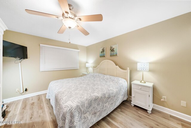 bedroom with ceiling fan and light hardwood / wood-style flooring