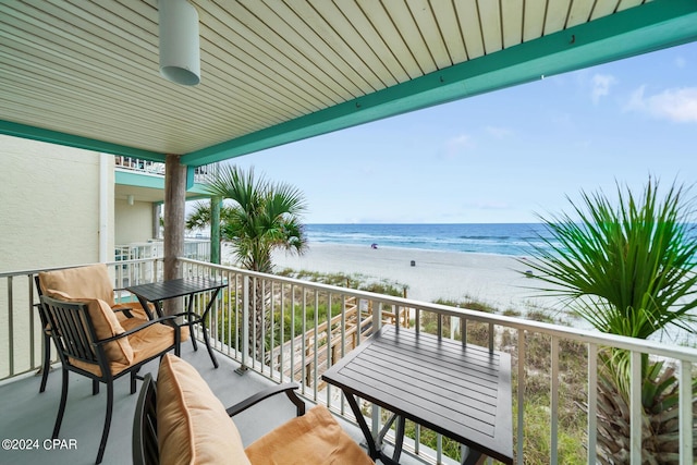 balcony with a beach view and a water view