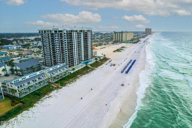 drone / aerial view with a beach view and a water view