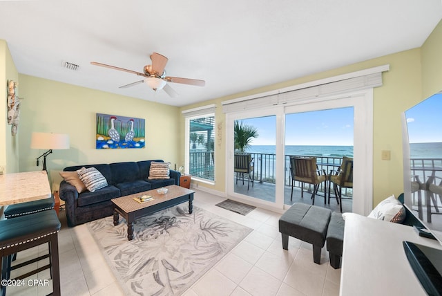 tiled living room featuring ceiling fan