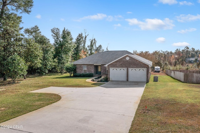 view of front of property featuring a garage and a front lawn