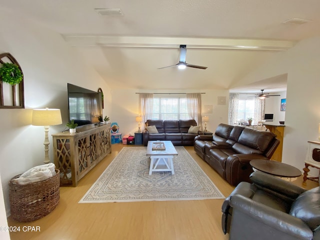 living room with lofted ceiling with beams and light hardwood / wood-style floors