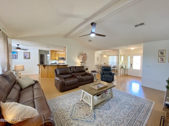 living room featuring vaulted ceiling with beams and ceiling fan